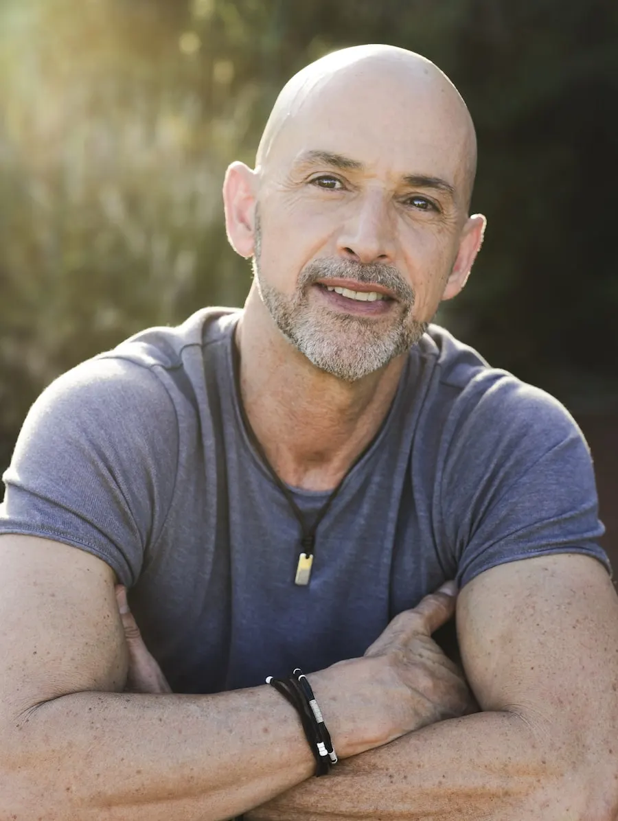 Man in his fifties outdoors, arms crossed